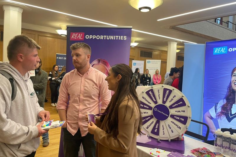 employers talking to a student at a Careers Fair